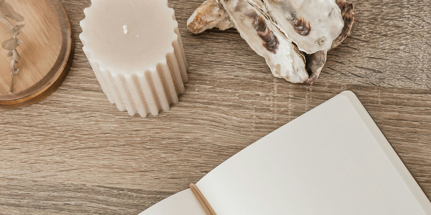 Un cuaderno abierto sentado encima de una mesa de madera — Inflación del estilo de vida: el enemigo silencioso