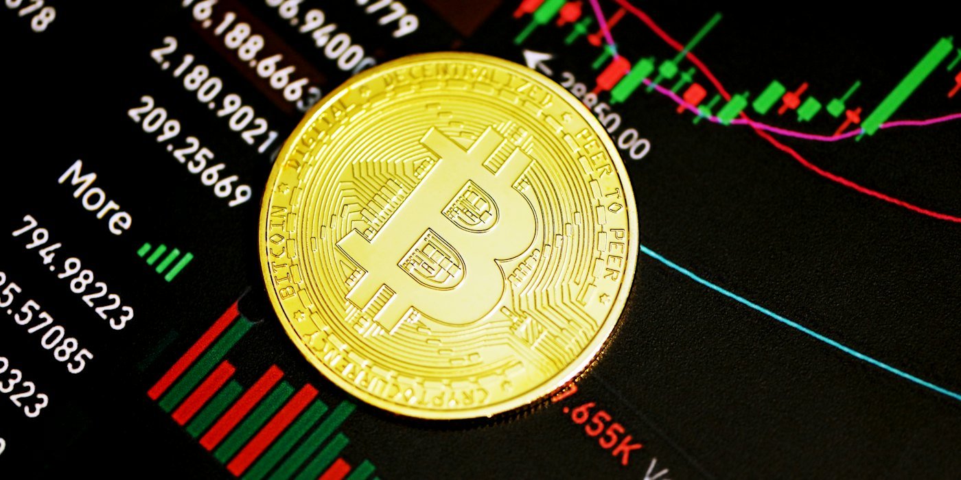 Moneda redonda de oro sobre superficie negra — Staking: qué es y qué riesgos tiene